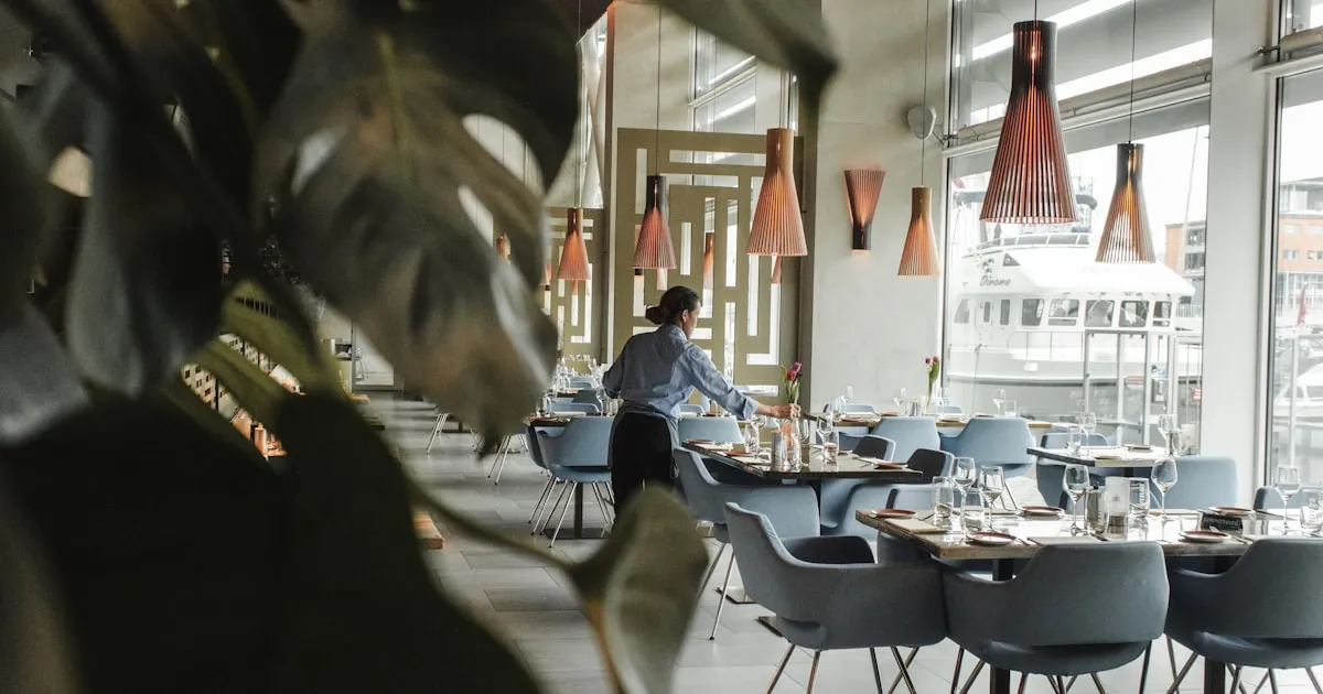 Customers seated in a lively restaurant checking Google reviews on their phone