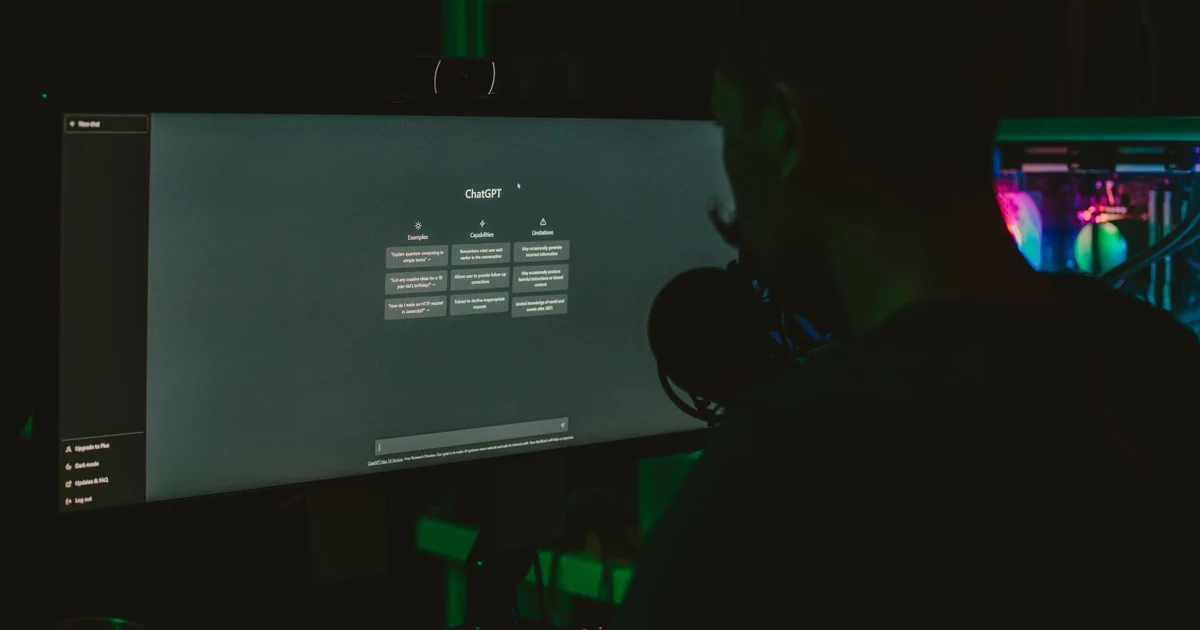 Person using ChatGPT on a large screen in a dark room