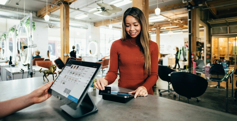 Store owner digitising their point of sale with connected devices to streamline the customer journey.