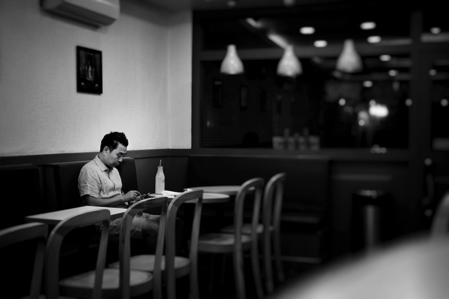 Shop owner sending a bulk SMS campaign from their smartphone