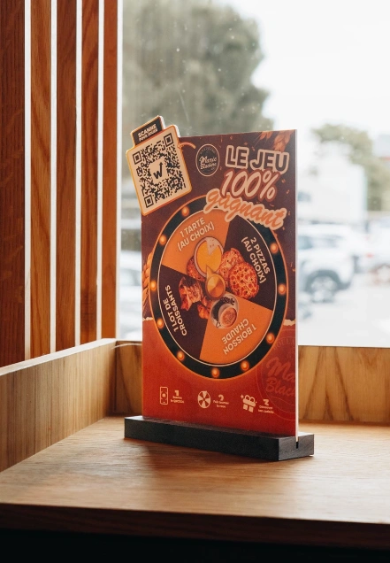 Marie Blachère 100% winning game stand with QR code near the bakery window