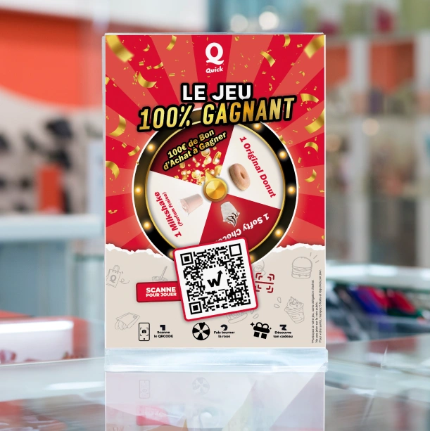 Laminated Quick 100% winning game flyer with prize wheel and QR code on a counter