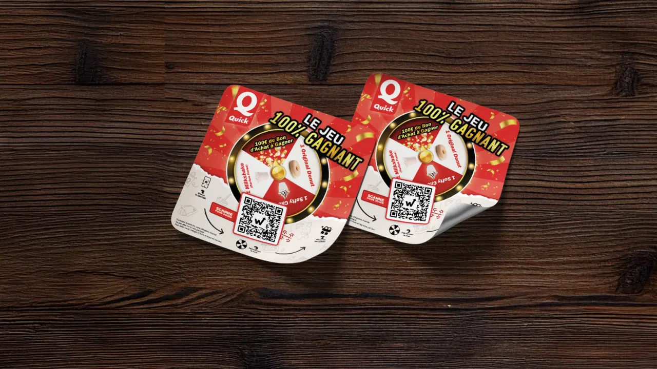 Quick prize game stickers with QR code and prizes to be won on a wooden table