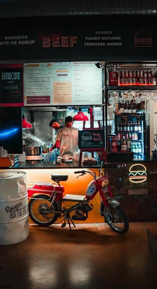 Rouge Beef restaurant counter with its red moped and burger neon sign