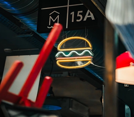 Burger neon and 15A sign in the Rouge Beef dining room